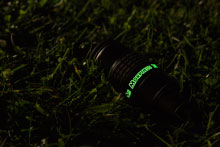 Morpheus with luminescent lettering lying in the Grass